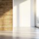 moderner leerer wohnraum mit ecke aus holz und weisser wand bei tageslicht
